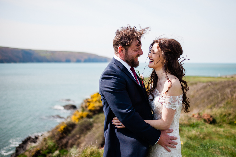 The Cliff, wedding couple, laughing, unposed, wind in hair, happy natural wedding couple, 