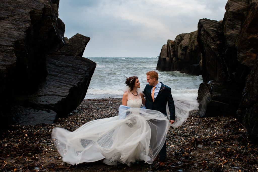 wedding couple on the beach at the cliff hotel and spa